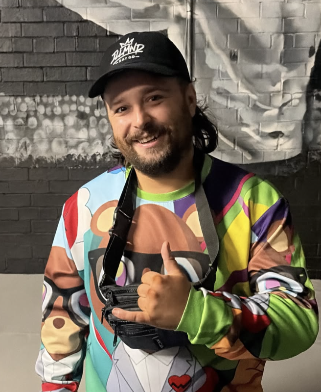 Black Genesis cap worn with a graphic sweatshirt