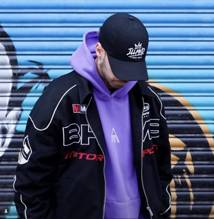 Black Genesis cap worn with a motorsport jacket